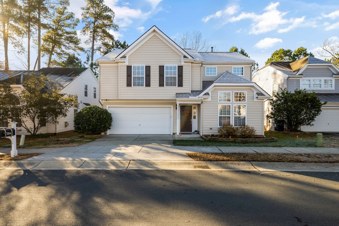 An image of a house with a white garage door