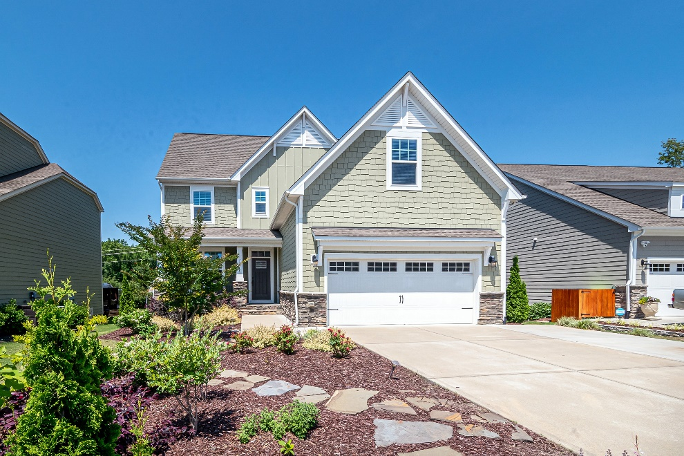  A house with two garage doors and a planter