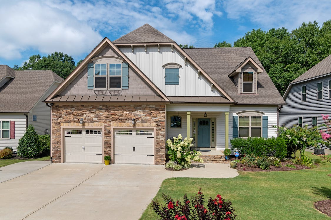 An image of a house with a white garage door