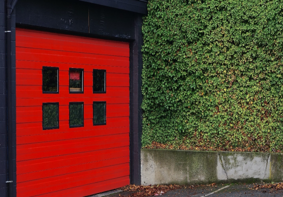 Red garage door with six glass windows.