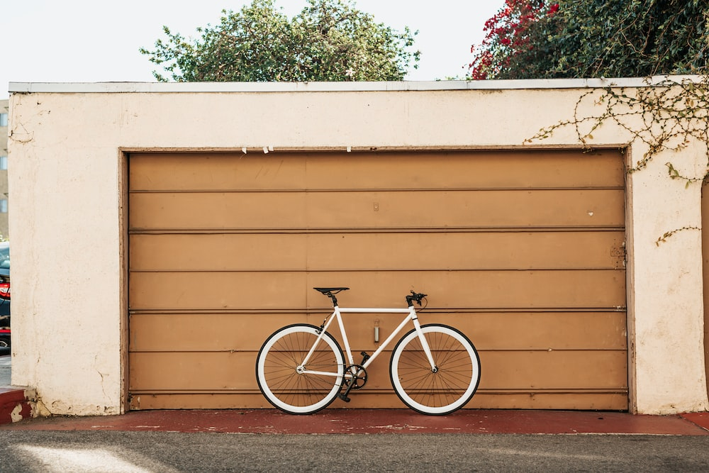 cycle parked in front of a garage door