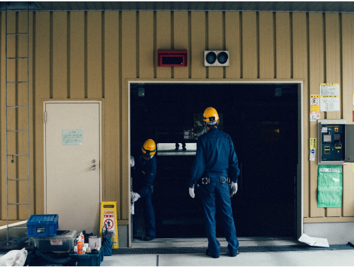 Workers fixing a garage door.