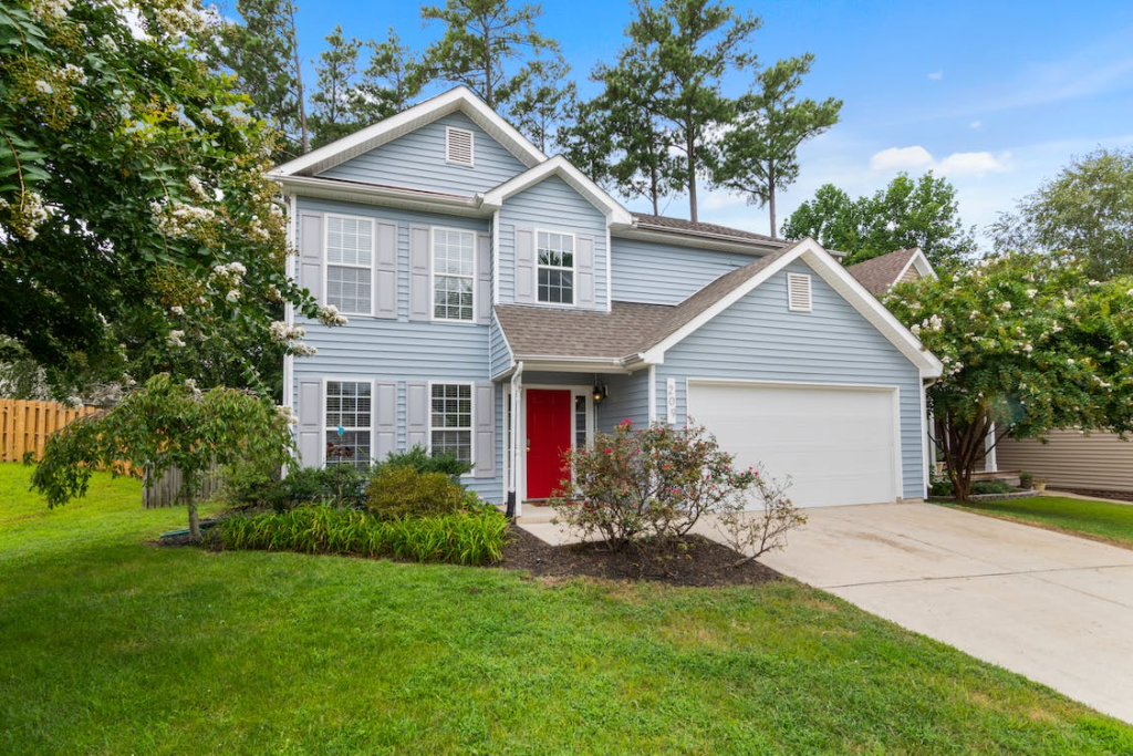 An image of a house with a white garage door