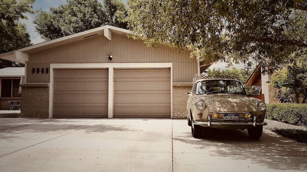 an old car parked near a garage door