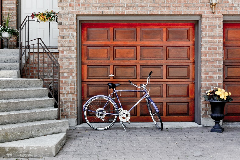 A custom garage door made of wood, with a blue bike leaning against it.