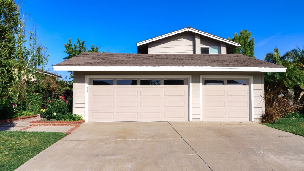 A home with two large garage doors with clear windows
