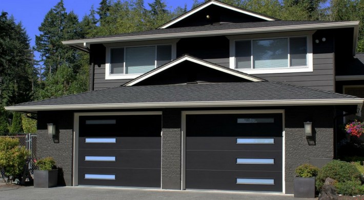 Black House with a Blue & Black Garage Door