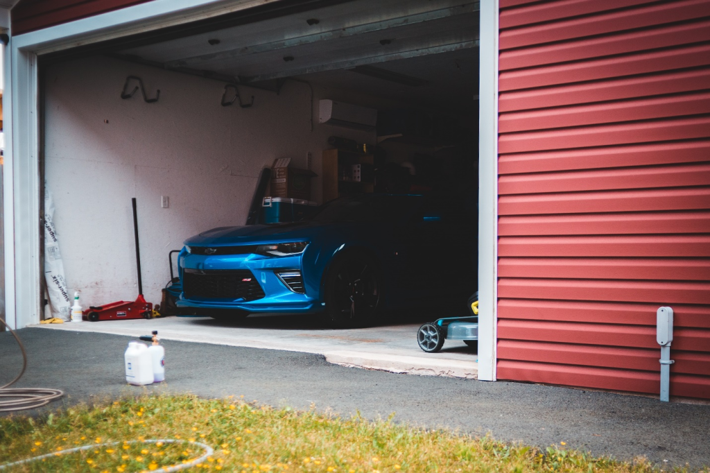 Blue car parked in a garage.