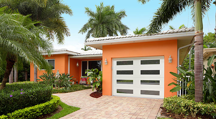 Orange house with a white garage door.