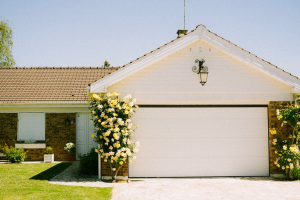 Garage driveway with flowering plants on the side