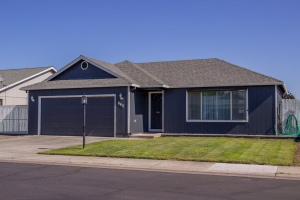 A modern dark grey house with a modern smart garage