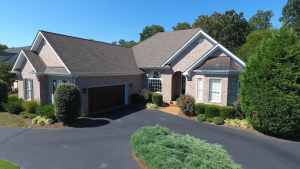 An image of a house with a brown garage door