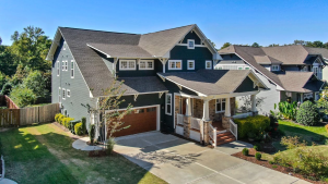 An image of a house with a brown garage door