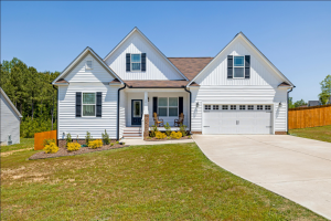 light blue house with 2 white garage doors